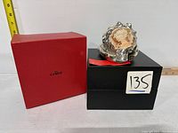 Photo showing the entire lot including the silver-dipped conch shell cameo positioned on black box with a red presentation box on left. Lot number 135 visible.