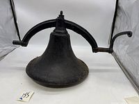 Front view showing the bell with mounting bracket and lever arm.