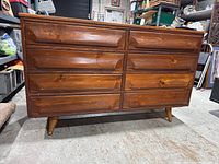 Front view of dresser showing all six drawers and angled legs