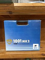 Front view of the blue box labeled Nady 1001 MK2 VHF Wireless Microphone System with a handle on top.