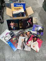 Photo showing a box filled with vinyl albums including Mahalia Jackson and Teddy Pendergrass records, arranged with some leaning against the box.