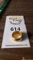 Ring displayed on Rest Easy Removals lot card, showing overall shape and finish