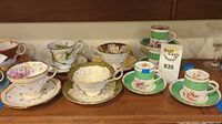 Various Paragon bone china teacups and matching saucers displayed on a shelf.