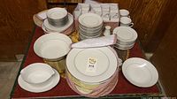 Full overview of Noritake Tahoe fine china set showing plates, cups, saucers, bowls, and serving pieces arranged on table.