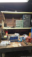 Wide shot of workbench with assorted tools, storage drawers, and fire extinguisher on lower shelf.