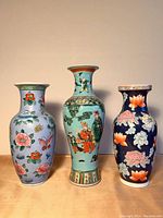 Front view of all three vases showing colors, patterns, and relative heights