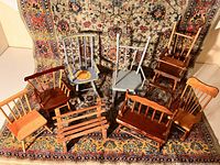 Overview of all 8 wooden doll furniture pieces displayed on patterned rug