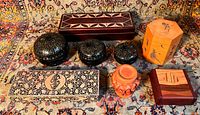 Overview of all eight handmade boxes showing variety in shapes, materials and decorations including leather, wooden marquetry, lacquer, and painted boxes