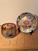 View of the porcelain plate and glass bowl together, showing size and decor of both items
