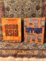 Front view of both books "Inside Asia" and "Inside Africa" placed on patterned fabric background.