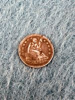 Front obverse side showing Seated Liberty figure with date 1853 and stars