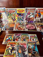 Photo showing several vintage Spider-Man comics arranged in two rows, featuring Amazing Spider-Man, Spectacular Spider-Man, Sensational Spider-Man, and others.