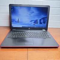 Front view of HP 15-inch touchscreen laptop showing the screen, keyboard, and touchpad.