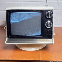 Front view of the powered on Viking TV showing static on screen and visible dials.