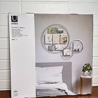 Boxed Umbra Infinity Wall Multi Photo Display showing branding and product image