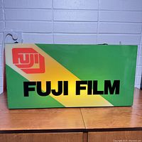 Front view illuminated showing printed Fuji logo and text on colored background