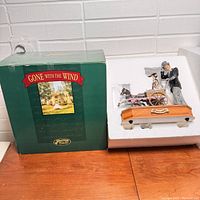 Music box scene featuring a man, woman, baby in carriage pulled by horse, wooden base with Gone With The Wind plaque, original green box packaging