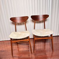 Front view of both chairs showing seat upholstery and backrests