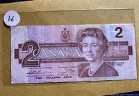 Front side of the 1986 Canadian $2 Dollar banknote showing Queen Elizabeth II and denomination markings.
