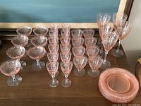 Full set view: eight dessert plates stacked right, rows of cordial, champagne, goblets and sherbets