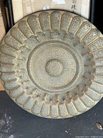 Full view of large round brass tray showing scalloped edge and overall shape