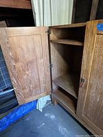 Open front door showing interior shelving and solid oak construction.