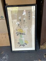 Framed Asian floral print in faux bamboo style frame with visible faded colors and calligraphy text.