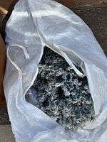 The Christmas tree partially inside a white storage bag, showing the overall size and size of the bag.