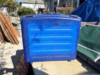 Photo of the blue plastic Suze Orman finance kit carrying case, showing front with embossed text.