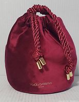 Full front view of the velvet beauty bag showing its shape, color, and drawstring closure