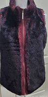 Full front view of reversible vest showing faux fur texture and zipper