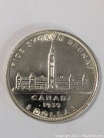 Front side of the 1939 Canada Silver Dollar coin showing Parliament Buildings and inscriptions.