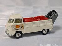 Side view of white and red Corgi Volkswagen tow truck with Racing Club decal on door, showing condition and details of paint.