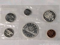 Sealed plastic holder with all six 1963 Canadian coins visible, showing different denominations and designs.