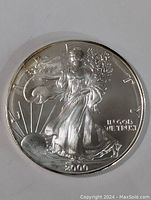 Front side of the 2000 silver American Eagle coin showing Lady Liberty with sun rays and inscriptions
