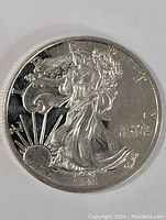Front face of the silver bullion coin showing full Walking Liberty design, sun rising, and inscriptions.