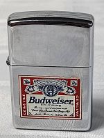 Front view of chrome Zippo lighter with Budweiser label showing overall condition and design.