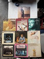 All 9 vintage vinyl records laid out on a surface showing various artists and album covers