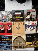 Top view of 7 vintage vinyl records arranged on a white surface showing album covers for Walter Hawkins, Donna Summer, Doris Duke, Ferrante & Teicher, and others.