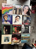 Overview photo showing 12 vintage vinyl records with various album covers