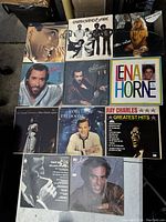 Overview of ten vintage vinyl records with various album art and artists including Earth Wind & Fire, Lena Horne, and Ray Charles.