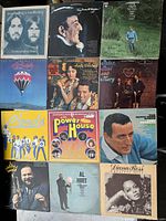Photo of 12 vintage vinyl records overlapping in three rows showing various album cover art and artist names