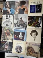Top view of an assortment of vintage vinyl records including Pat Benatar, Liberace, The J. Geils Band, and others.