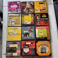 Top view of all 12 vintage vinyl record album covers arranged in a 3x4 grid on a flat surface.