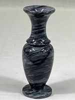 Full view of the small gray marble bud vase displaying its shape and polished finish with black swirls.