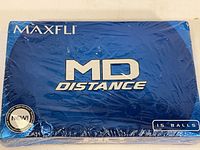 Blue sealed shrink-wrapped box of 15 Maxfli MD Distance golf balls showing front with branding and quantity