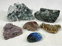 Overview of all six mineral specimens on a white background showing varying textures and colors.