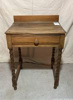 Front view of antique pine washstand showing single drawer and barley twist legs.