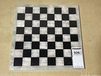 Full view of 14x14 inch black and white marble chessboard with checkered pattern of alternating squares.
