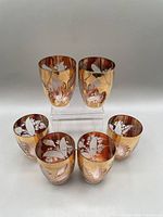Set of six matching etched gold cocktail glasses shown together, highlighting the gold finish and etched floral patterns.